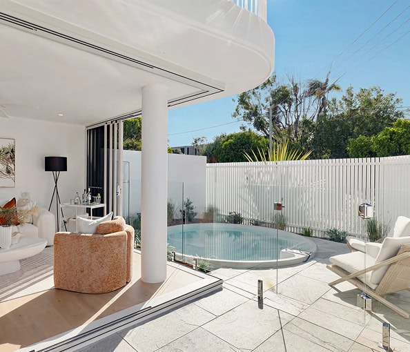 Modern outdoor living space with pool and lounge area at 4575 Properties.