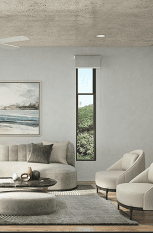 Modern living room with neutral tones and large window overlooking greenery.