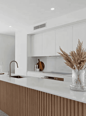 Modern kitchen with white cabinets and wooden accents, minimalist design.