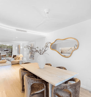 Modern dining area with a wooden table and stylish chairs in a bright home.