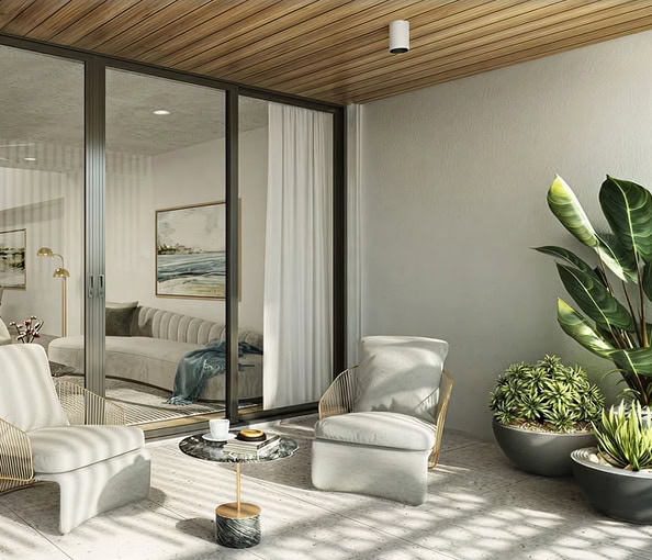 Contemporary balcony with seating and potted plants in a residential property.