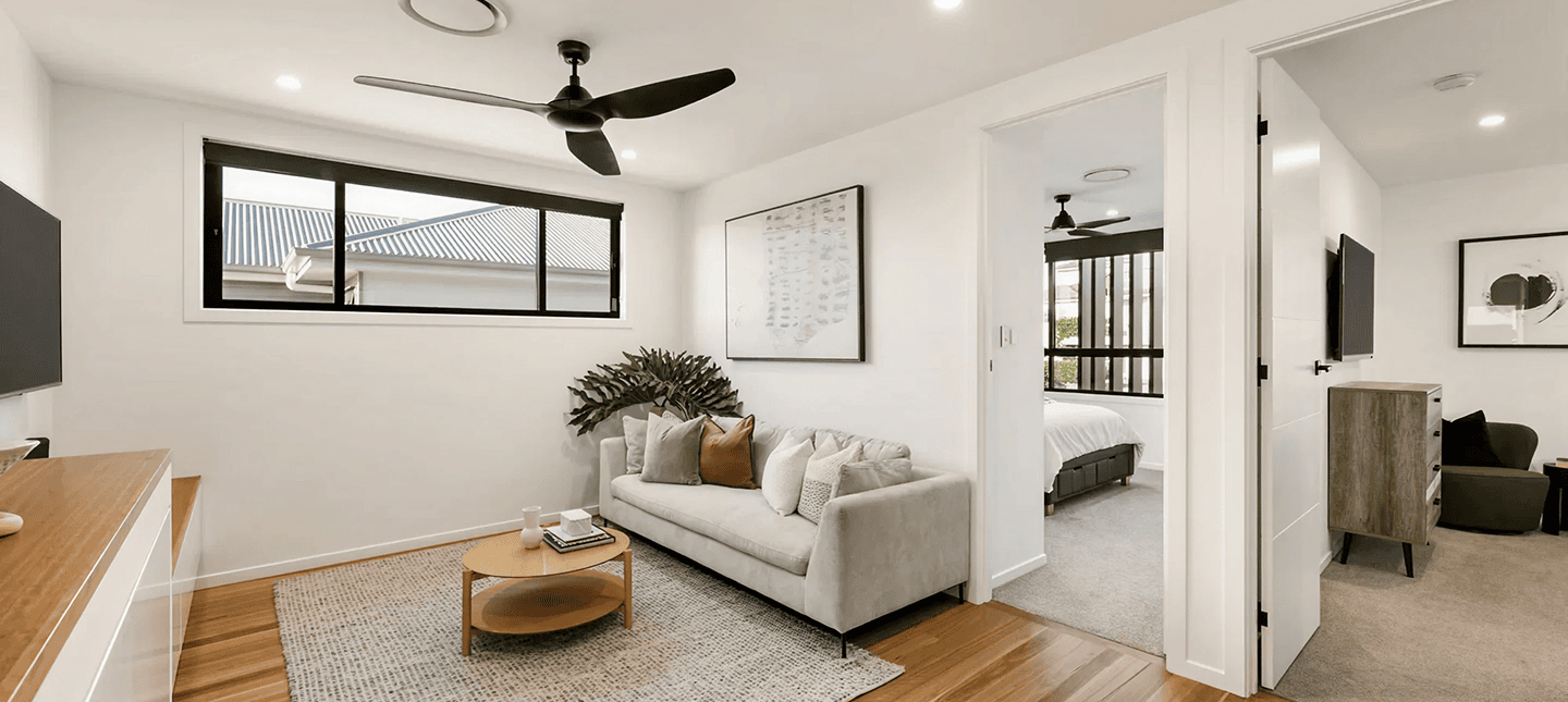Modern living room with white walls, large window, and minimalist decor.