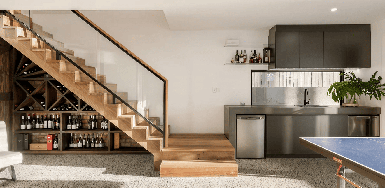 Modern kitchen with sleek grey cabinetry and open shelving in a stylish home.